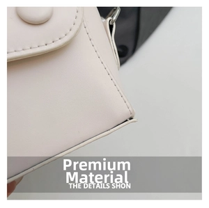 Macro detail of white leather mini bag featuring decorative round button and precise stitching