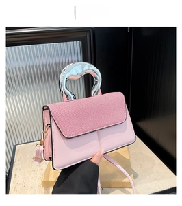 Detail of pink contrast flap bag with metallic silver handle and striped texture detail