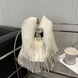 Elegante borsa tote bianca con frange e trama litchi su un supporto in metallo