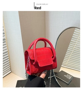 Detailed view of mini red crocodile pattern handbag with silver chain and magnetic closure
