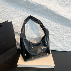 Glossy black underarm bag with silver stud details and modern structural design