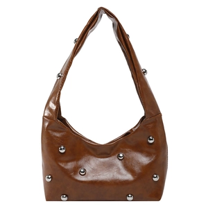 Brown rivet studded hobo shoulder bag in faux leather with crescent moon shape design