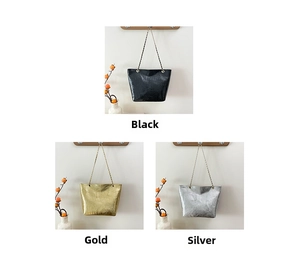 Close-up of three glossy crocodile-patterned tote bags in black, gold, and silver finishes