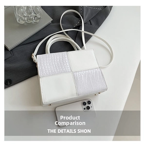 Détails du sac blanc à motif crocodile avec clous de protection métalliques au fond