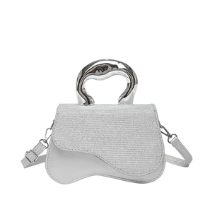 Silver sequin crossbody bag with a unique metallic handle and adjustable shoulder strap
