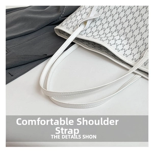 Detail of comfortable thin shoulder straps and letter print on a white tote bag