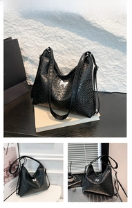 Detail of black woven PU leather tote bag featuring a silver butterfly metal ornament