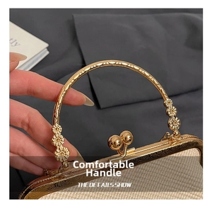 Detailed macro of woven shell bag with golden ring handle and floral metal clasp