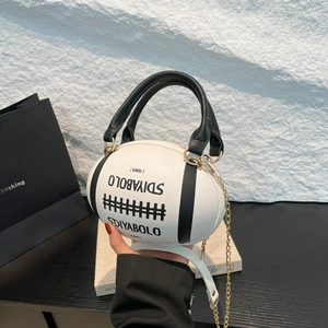 Rugby shaped handbag in black and white pebbled leather with a gold chain strap