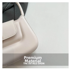 Macro shot of off-white leather texture and precise stitching on the flap shoulder bag
