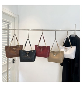 Close-up of crocodile pattern leather tote bags with elegant gold deer pendant and chain straps