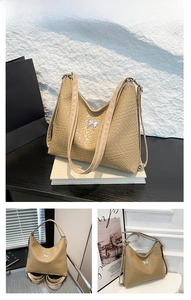 Detailed view of khaki woven hobo bag featuring silver butterfly buckle and long shoulder strap