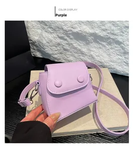 Detail view of purple leather mini crossbody bag with silver buckles and flap closure