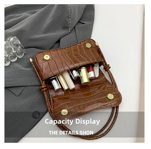 Brown crocodile texture shoulder bag interior showing storage for lipstick and phone