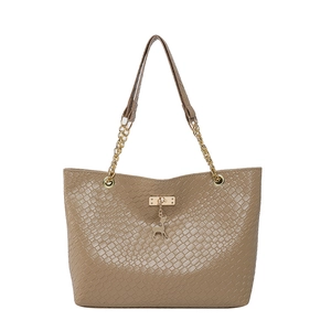 Khaki crocodile pattern tote bag with gold chain strap and deer charm on white background