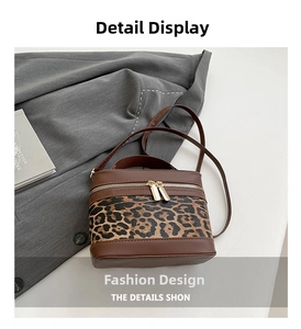 Detail of trendy box bag showing leopard print patchwork and gold double zippers