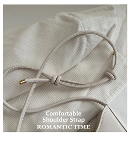 Detailed view of the soft white leather shoulder strap featuring an elegant knot design