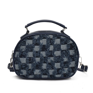 Blue denim checkerboard shell handbag with fringed edges and a leather handle