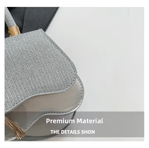 Detailed view of silver sequin fabric with fringe tassel and metallic saddle bag texture
