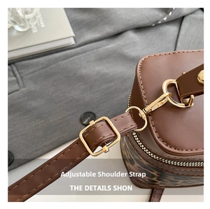 Detail of adjustable shoulder strap with gold hardware and leopard print accents