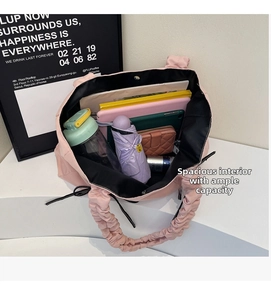Spacious pink nylon tote interior showing large capacity for laptop, water bottle, and books