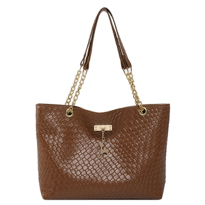 Brown woven texture tote bag with golden chain straps and a deer charm on white background