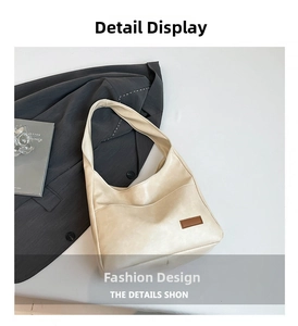 Detail of off-white oversized faux leather tote bag with dark brown decorative label