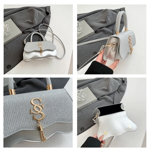 Detail of silver glitter crossbody bag with wave-edge flap and golden S-shaped hardware