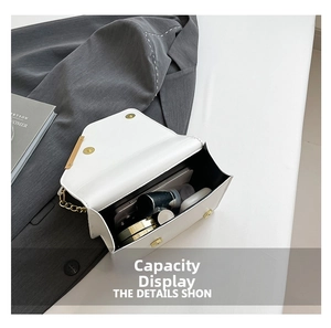 Interior capacity of white crossbody bag showing phone, lipstick, and essentials
