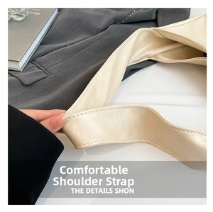 Detail of comfortable shoulder strap on minimalist beige tote bag with fine stitching