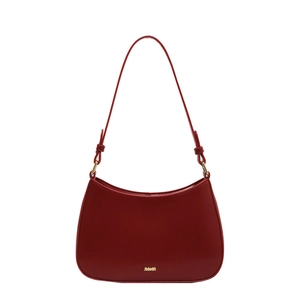 Minimalist deep red glossy leather shoulder bag with gold metal lettering on white background