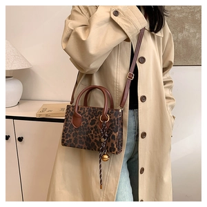 Fashionable leopard print large tote bag with leather handles and detachable shoulder strap