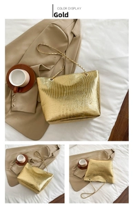Detail view of golden crocodile pattern handbag showing front and side angles with chain strap