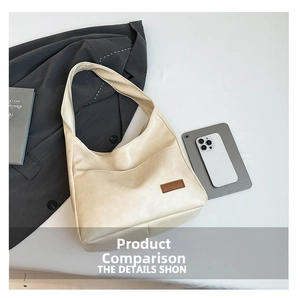 Detailed view of the creamy white tote bag with textured faux leather and brown patch
