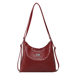 Red woven leather hobo shoulder bag featuring a silver butterfly buckle in a minimalist style