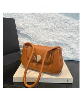 Dettaglio ravvicinato della borsa in pelle PU marrone con fibbia metallica dorata a cuore