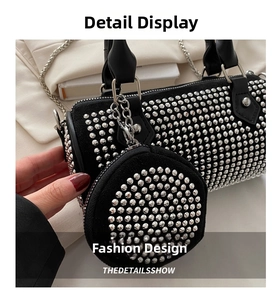 Detail of a black cylinder bag with silver studs and a matching round mini coin purse