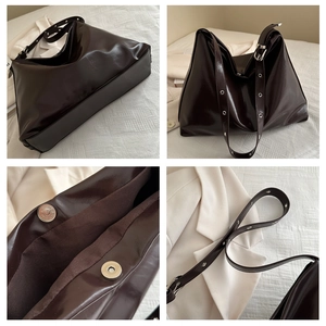 Detail view of coffee brown faux leather hobo tote with adjustable strap and magnetic buckle
