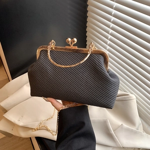 Chic black woven chain bag with gold sphere clasp and minimalist shell design
