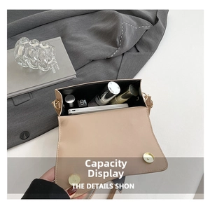 Top view of compact crossbody bag interior showing storage for phone and cosmetics