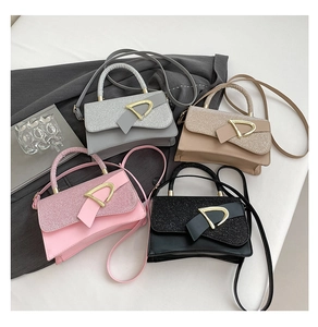 Top-down view of four colorful handbags with sequin patchwork and metal buckles