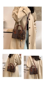 Detail of leopard print tote featuring metal handles and adjustable leather shoulder strap