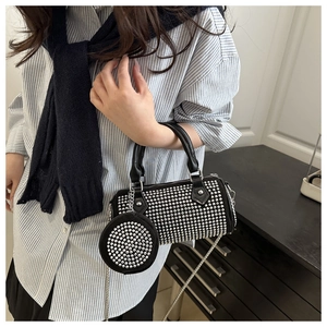 Detail of black Boston bag with silver studs and a matching round mini coin purse charm