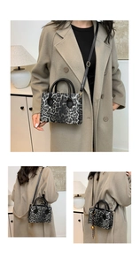 Macro detail of leopard print handbag with metallic sphere charm and black leather handle