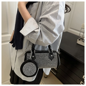 Chic black rhinestone cylinder bag shown on body with a matching mini round coin purse