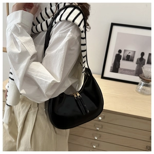 Fashionable black crescent shoulder bag shown on model for daily lifestyle styling