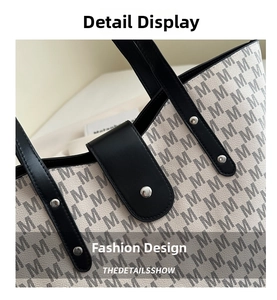 Detailed macro view of the black leather closure and metal rivet on the tote bag