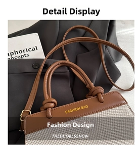 Detail of a brown leather and gray woven tote bag with adjustable strap and fashion stamp