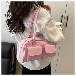 Pink PU leather shoulder bag with double flap pockets shown on model for size perspective