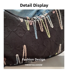 Detail of black embossed nylon bag with colorful 3D woven dripping embroidery lines